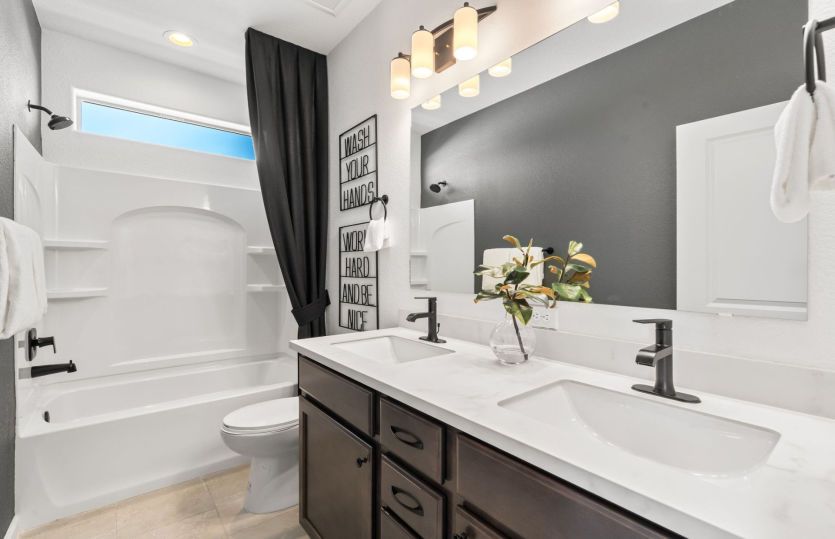 Bath with two sinks and a shower/tub combo located just outside upstairs bedrooms 2 and 3.