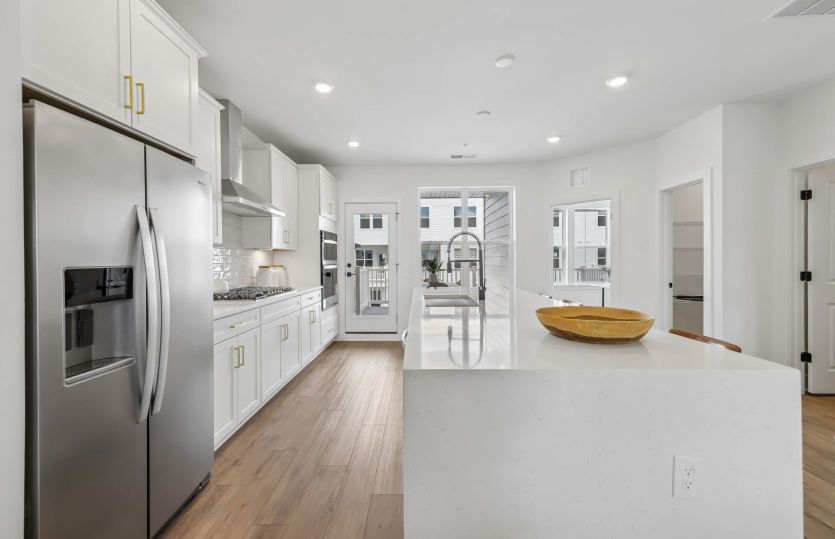 Gourmet Kitchen Features a Cascade Island - Actual Home