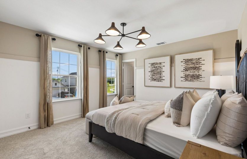 Spacious secondary bedroom with large windows *model representation