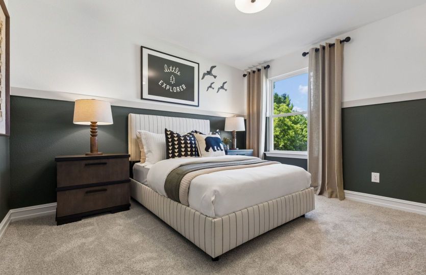 Spacious secondary bedroom with large window *model representation