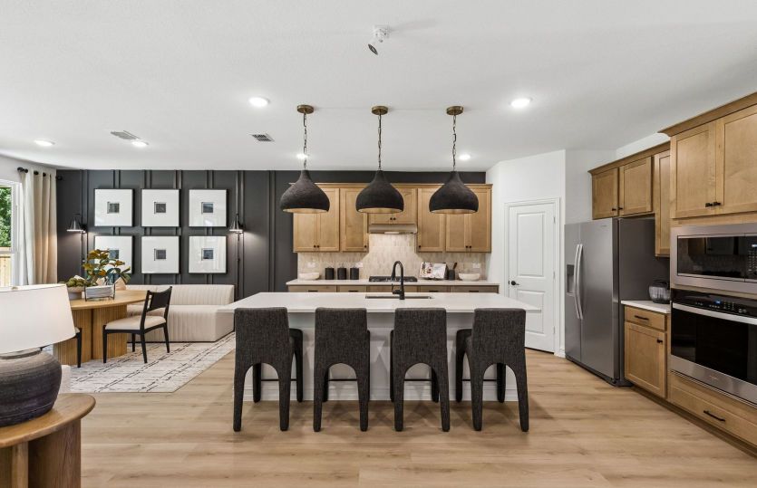 Spacious island kitchen with eat-in bartop and gorgeous pendant lighting