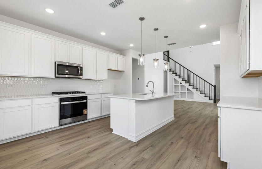 Kitchen overlooking main gathering areas *model representation