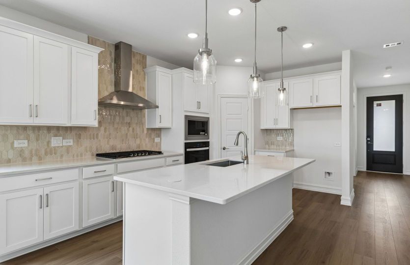 Eat-in bartop island and abundant cabinet space in kitchen