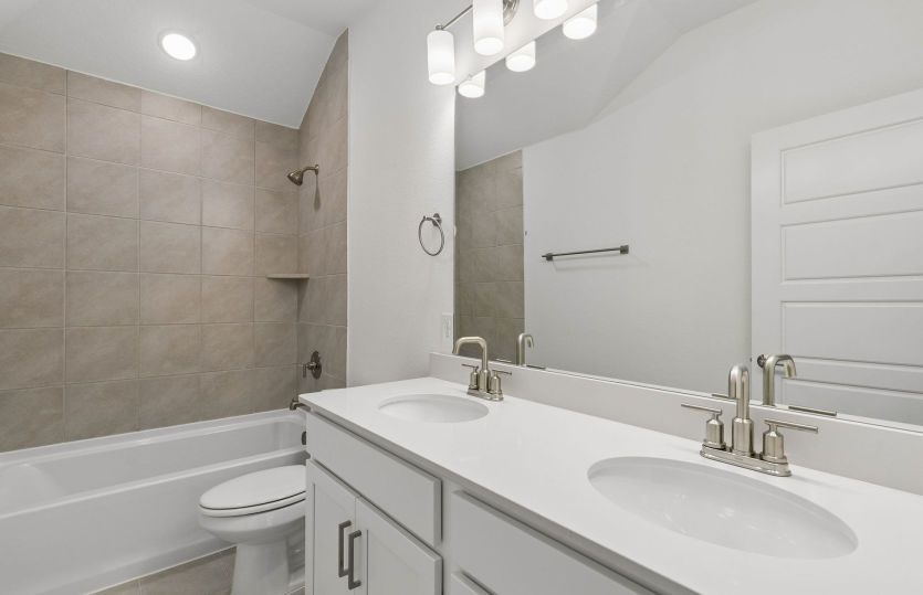 Secondary bedroom with two vanities