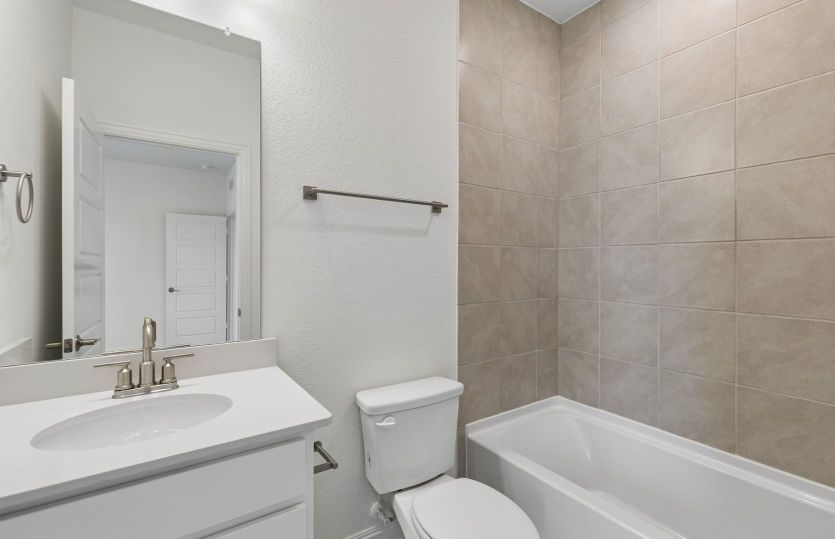 Secondary bathroom with tile surrounded shower