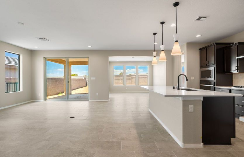 Expansive open-concept living area with abundant natural light and patio access