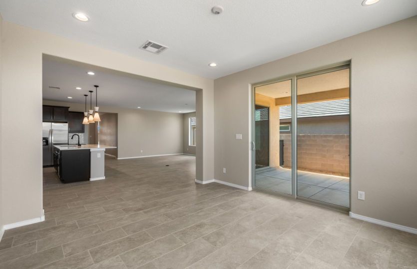 Seamless flow from kitchen to dining area to back patio
