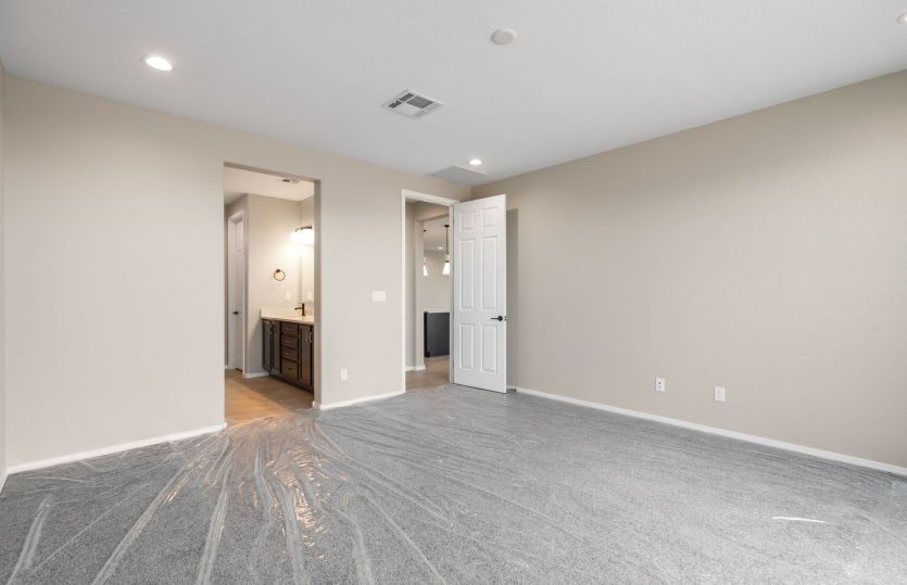 Private owner's retreat with an en-suite bath and direct access to the main living area