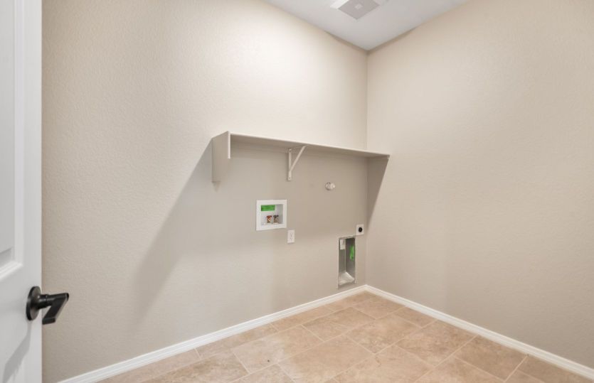 Functional laundry room with built-in shelving and ample storage space