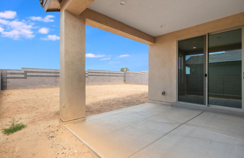 Covered patio overlooking a spacious backyard ready for your personal touch