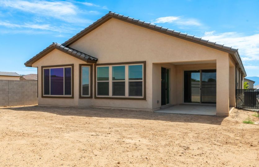 Rear exterior showcasing the covered patio and seamless indoor-outdoor living
