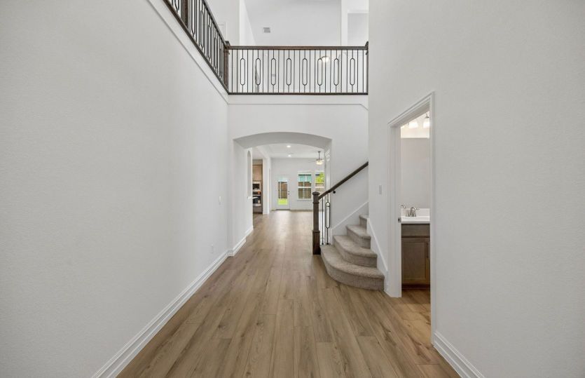 Welcoming entry into home with soaring ceilings
