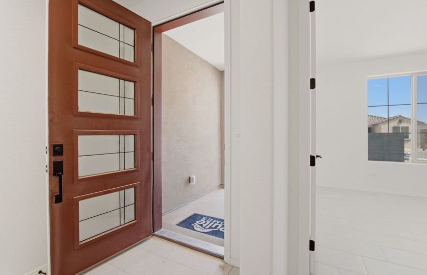 Modern entryway featuring a striking glass-panel front door and welcoming foyer