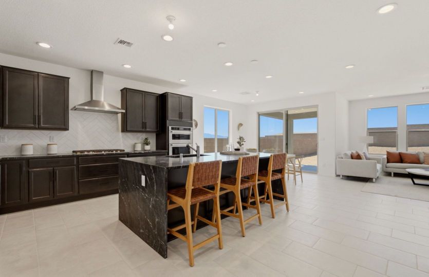 Beautiful gourmet kitchen featuring premium finishes and seamless flow into the dining and great room