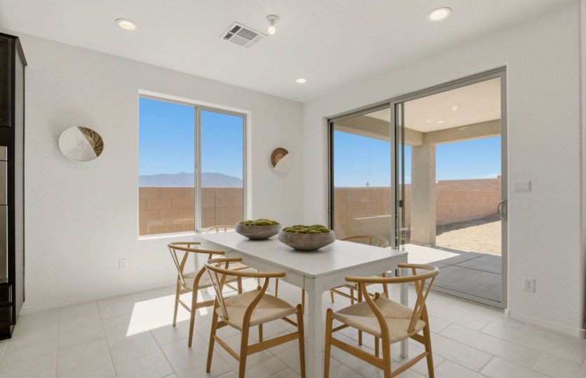 Light-filled dining area with sliding glass doors leading to the covered patio