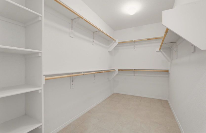 Expansive walk-in closet with built-in shelving and exceptional storage