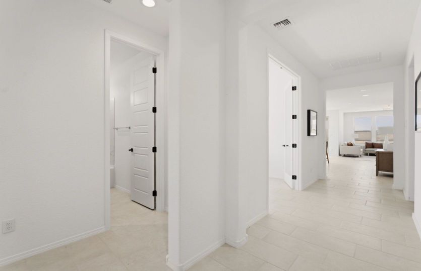 Wide hallway with easy access to secondary bedroom and the open-concept living area