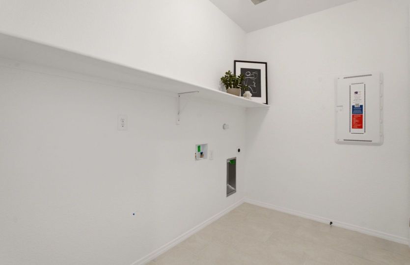 Spacious laundry room with built-in shelving and plenty of storage space