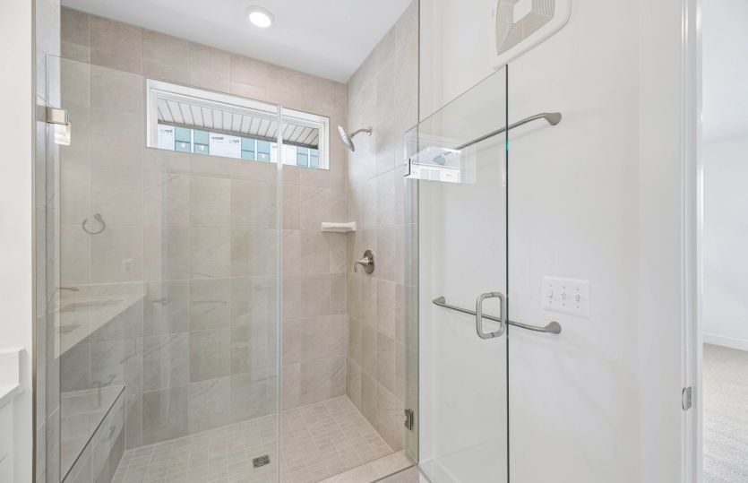 Frameless Glass Shower with Seat in the Primary Bath - Actual Home