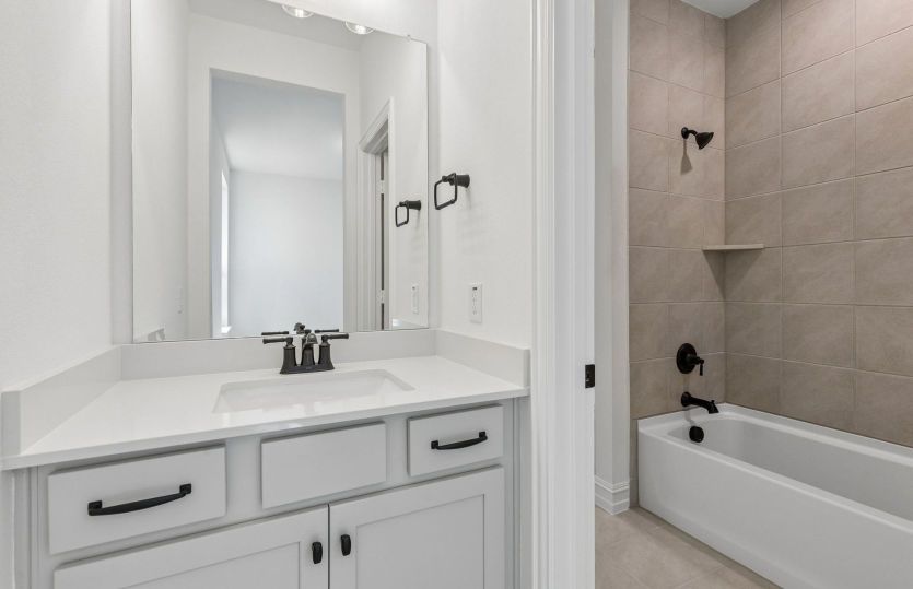 Secondary bath with tile surrounded shower *model representation