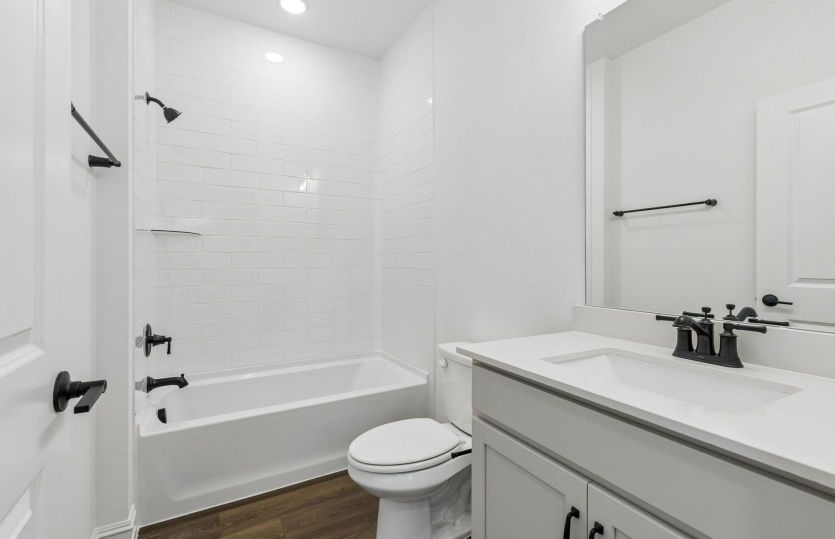 Tile surrounded shower in secondary bath *model representation