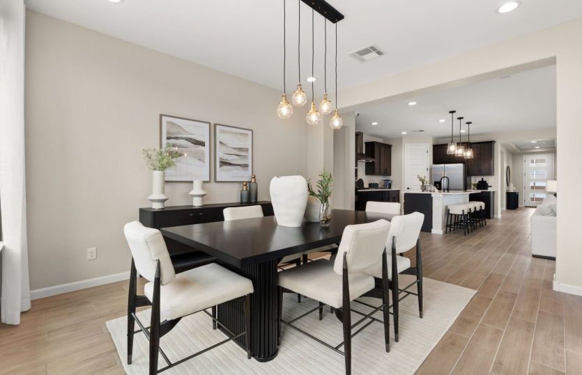 The well-lit cafe features a tray ceiling with decorative accents and access to the backyard and cov