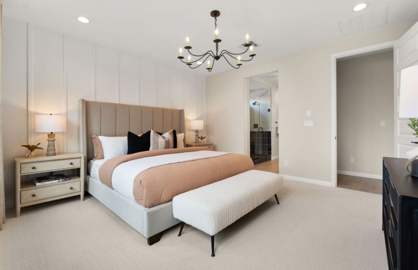 Your owner's suite oasis - a cozy room with an accent wall and a decorative lighting fixture.