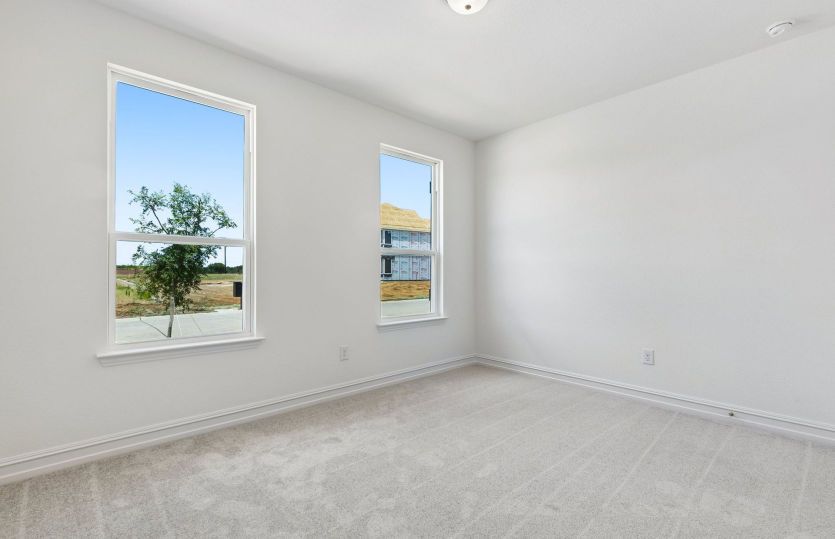 Secondary bedroom off home entry with large windows