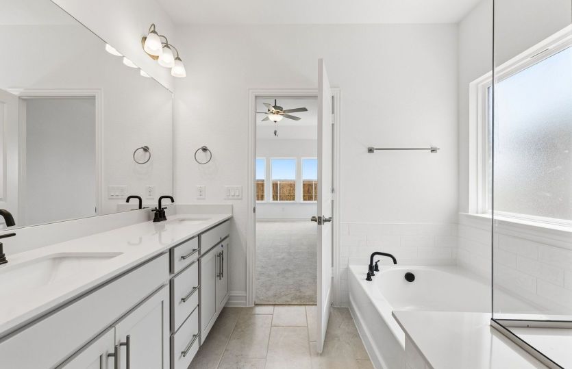 Owners bath with separate tub and beautiful shower