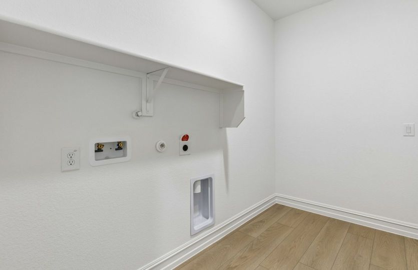 Laundry room with built-in shelving