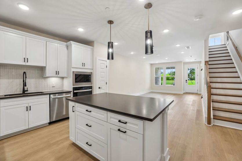 Large kitchen island overlooking gathering room