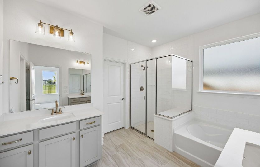 Separate vanities in owner's bath
