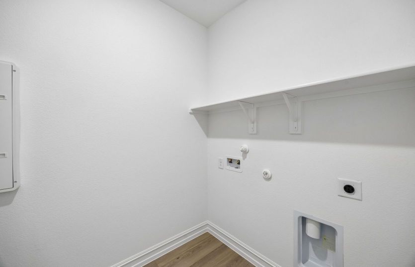 Laundry room with built-in shelving