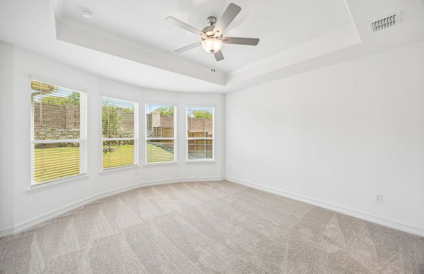 Primary bedroom with bay windows