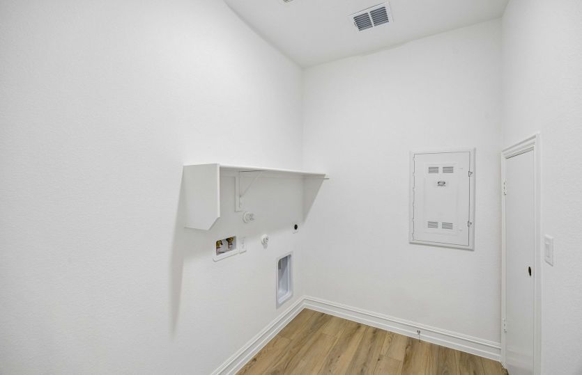 Laundry room with built-in shelving