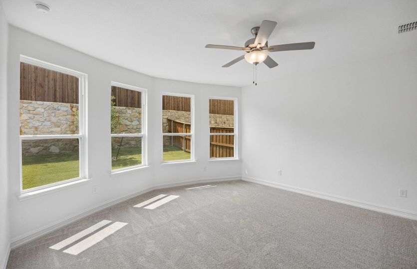 Primary bedroom with bay windows