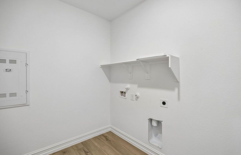 Laundry room with built-in shelving