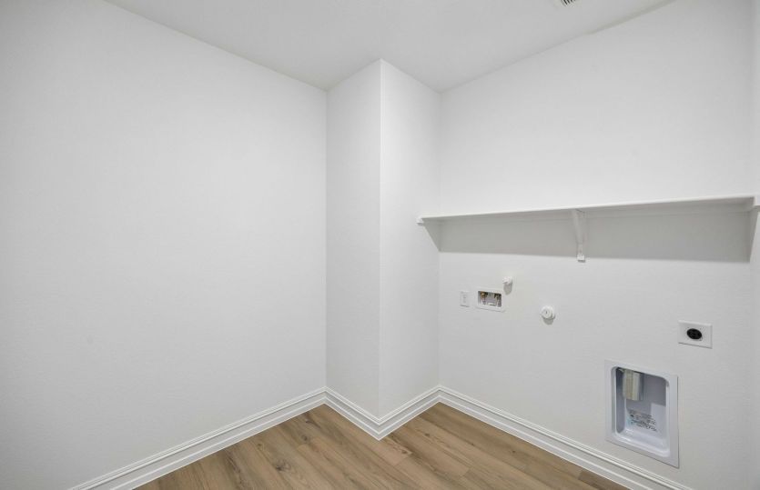 Laundry room with built-in shelving