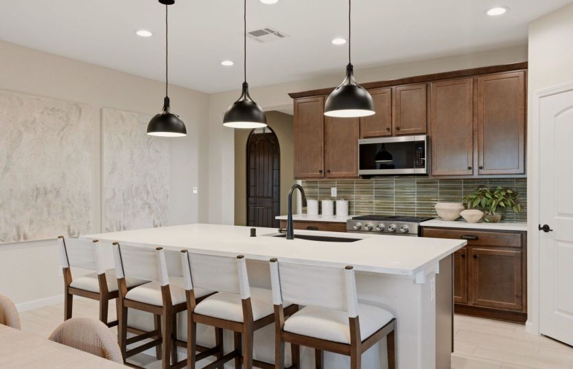 The Barlettta kitchen boasts functionality throughout with ample counter space, cabinetry, and a cor