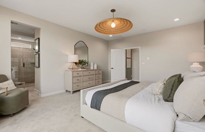 Enter the owner's suite featuring a wood accent wall and a stylish bay window upgrade.