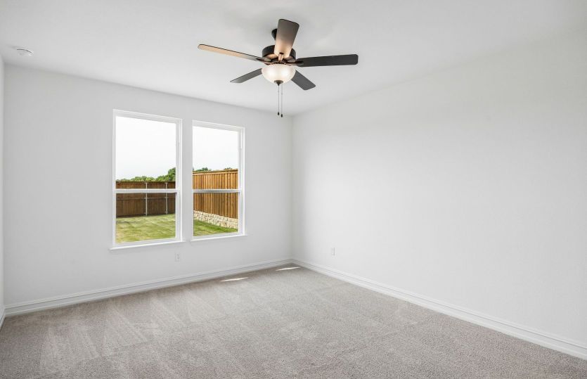 Primary bedroom with large windows