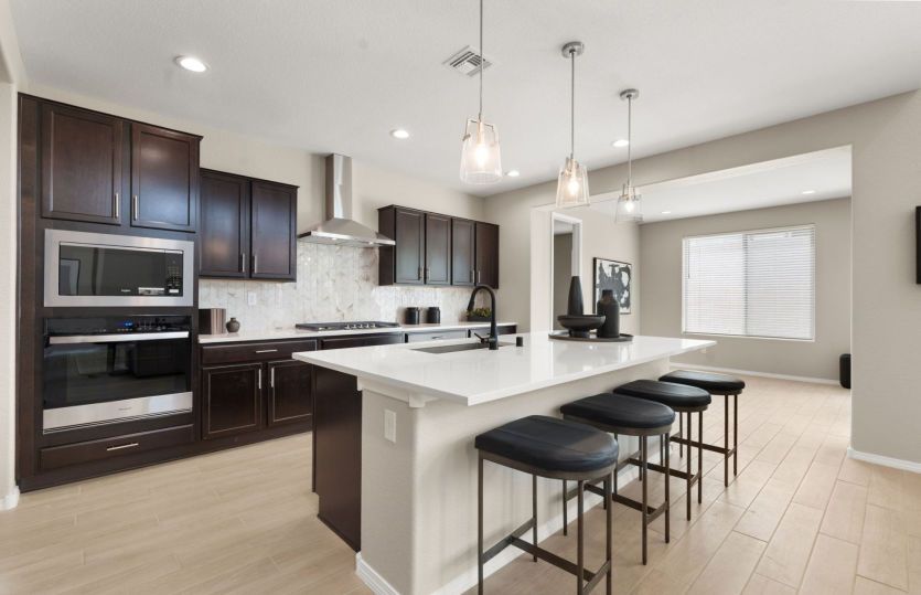 Chef's kitchen featuring oversized island and dark cabinets