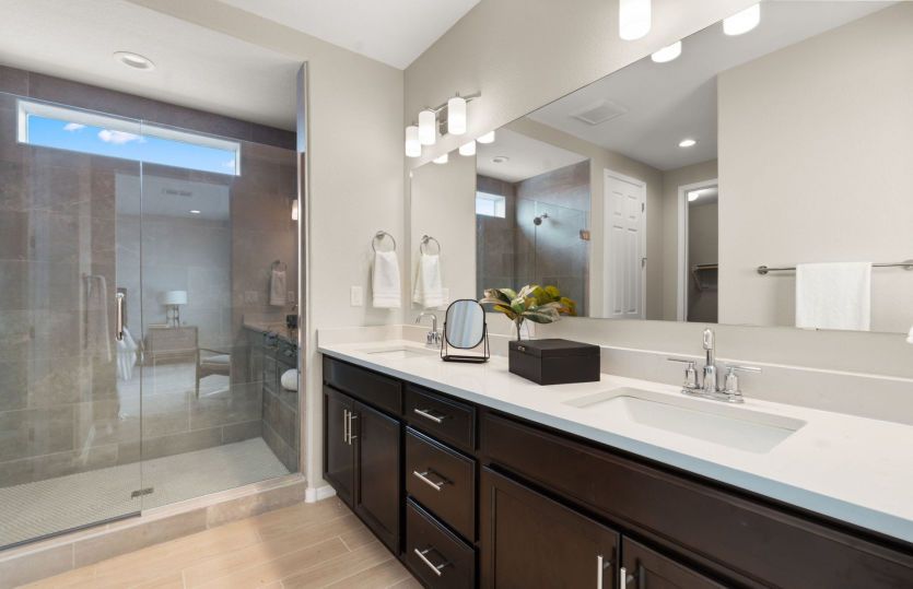Owner's bathroom with dual sink and frameless glass shower
