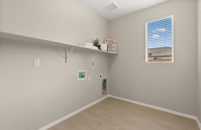 Functional laundry room with built in shelving for storage