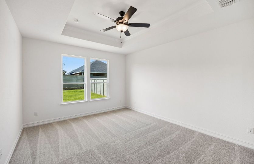 Primary bedroom with large windows