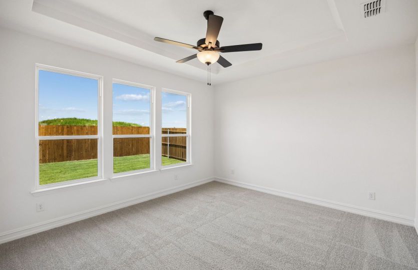 Primary bedroom with large windows