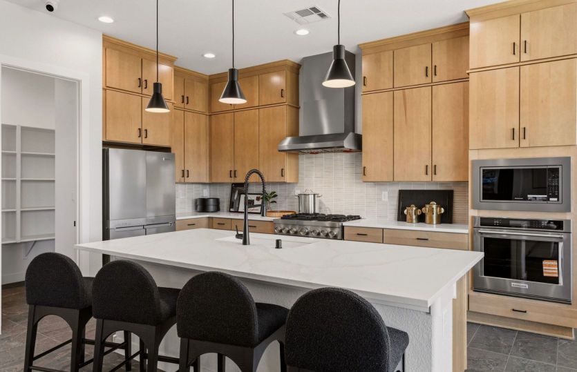 Built-in stainless-steel appliances complete the upscale Ravenna kitchen at Savio Ridge.