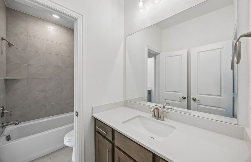 Secondary bedroom with tile surrounded shower