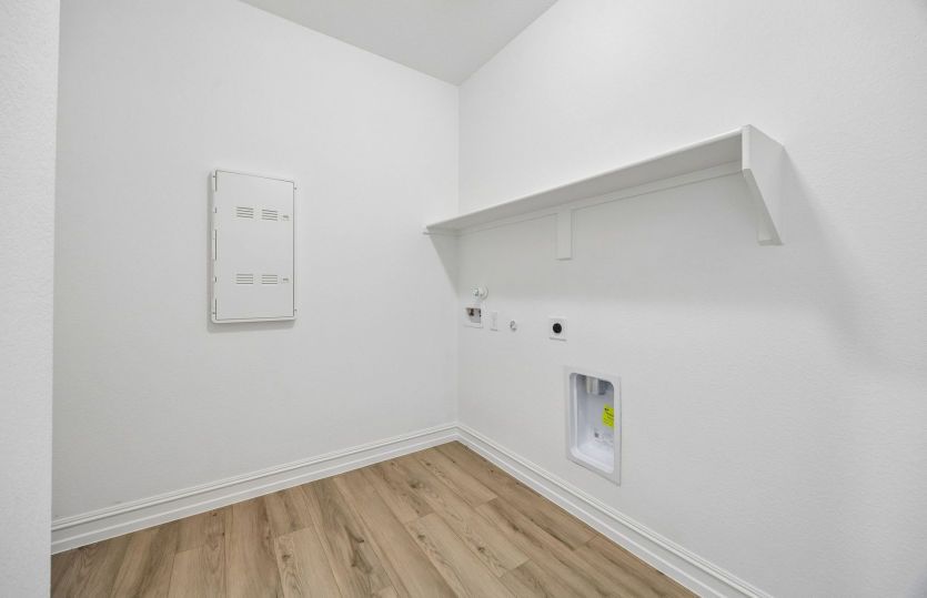 Laundry room with built-in shelving