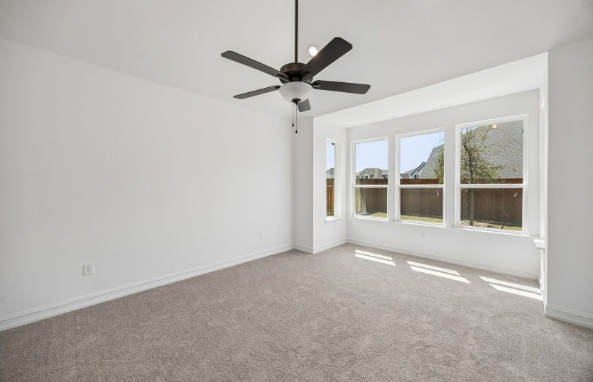 Primary bedroom with bay windows